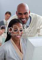 Portrait of two enthusiastic businesspeople working at a compute