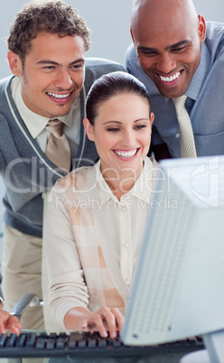 Attractive businesswoman and her colleagues working at a compute
