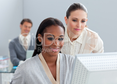 Portrait of two radiant businesswomen working at a computer