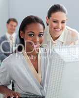 Portrait of two businesswomen working at a computer