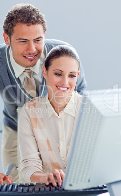 Pretty businesswoman and her manager working at a computer