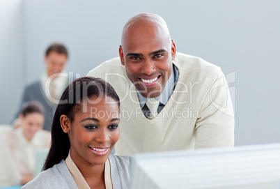 Portrait of two  attractive businesspeople working at a computer