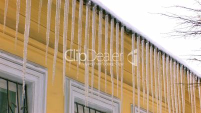 HD Dangerous icicles hanging from roof, closeup