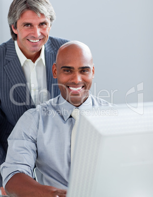 Two elegant businessmen working at a computer