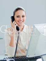 Enthusiastic businesswoman talking on phone