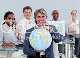 Fortunate business team at work showing a terrestrial globe