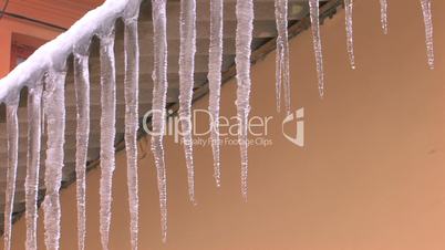 HD Dangerous spring icicles hanging from roof, closeup