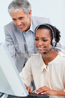 Diverse business partners working at a computer