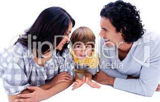 Attentive young parents with their son lying on the floor