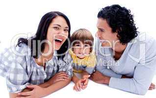 Laughing parents with their son lying on the floor