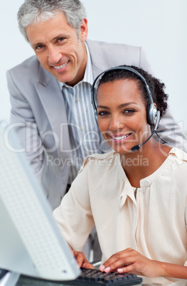 Smiling business people working at a computer