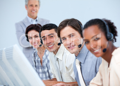 Cheerful business partners working in a call center