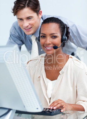 Cheerful business partners working at a computer