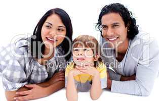 Smiling young parents with their son lying on the floor