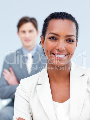 Charming business partners standing with folded arms