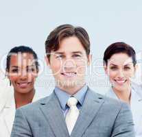 Smiling business people standing with folded arms