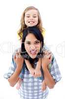 Joyful mother giving piggyback ride to her daughter