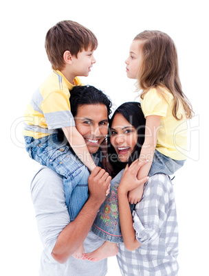 Smiling parents giving piggyback ride to their children