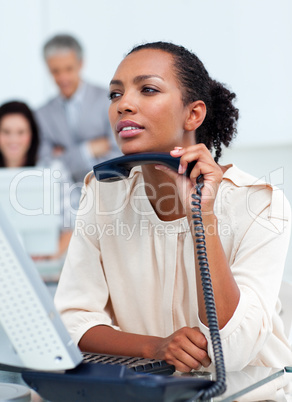 Confident businesswoman holding a phone