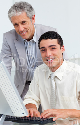 Cheerful colleagues working together at a computer