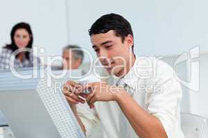 Serious businessman drinking a coffee at his desk