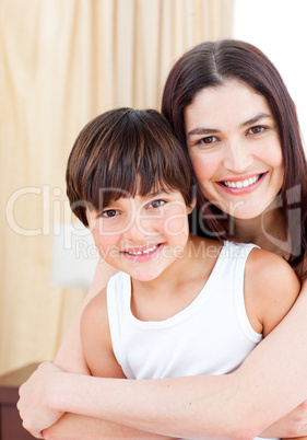 Smiling mother hugging her son