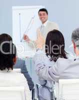 Senior businessman asking a question at a presentation