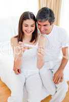 Smiling couple finding out results of a pregnancy test