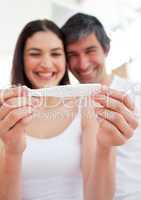 Cheerful couple finding out results of a pregnancy test