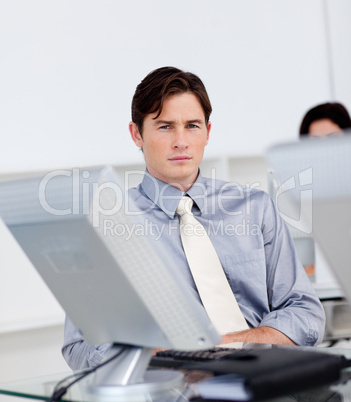 Charming young businessman working at a computer