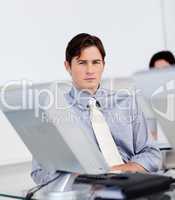Charming young businessman working at a computer