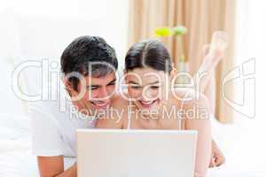 Affectionate couple using a laptop