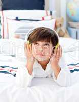 Cute little boy listening music with headphones on