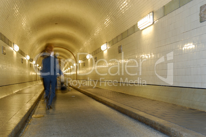 Woman is running in a tunnel