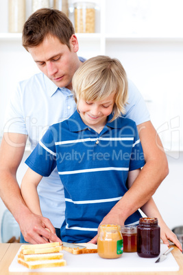 Adorable boy and his father preparing breakfast