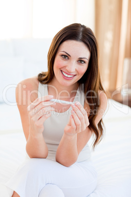 Joyful woman finding out results of a pregancy test