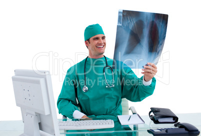 Positive surgeon looking at X-ray in his office