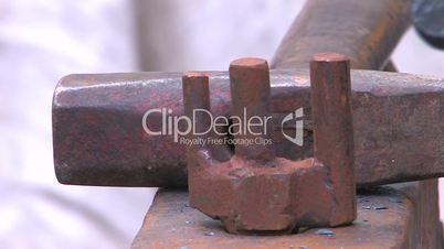 HD Craftsman working with metal by old fashioned way, with hammer and anvil, closeup