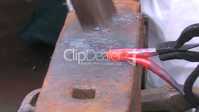 HD Demonstration of blacksmith skill, with hammer and anvil, closeup