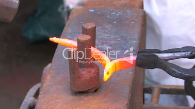 HD Blacksmith working with metal by old fashioned way, with hammer and anvil, closeup