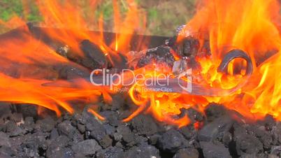 HD Super hot coals are heating metal bars in blacksmith, closeup