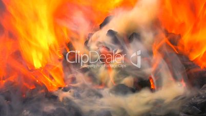 HD Sparks and flames from charcoal fire in blacksmith, closeup