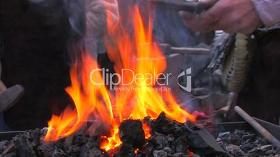 HD Demonstrative work of some blacksmiths with forge foreground