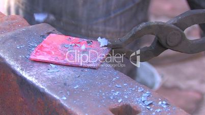 HD Processing of metal bar on the anvil, closeup