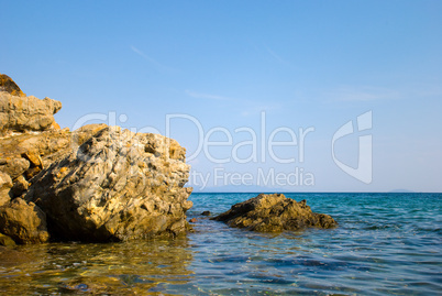Coast of sea with stones in water