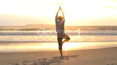 Geschäftsman macht Yoga am Strand
