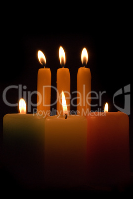 Burning candles over a black background