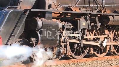 closeup of steam train moving off