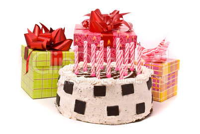 Pie with eleven candles and gifts in boxes on a white background