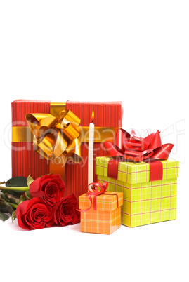 Red roses and gift boxes on a studio white background.